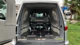 Interior of a 2013 Lincoln MKT with luxury seating and fixtures designed for a hearses layout featuring a sleek black floor and metallic accents