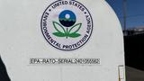 A white container with a circular United States Environmental Protection Agency logo featuring a blue and green design and a label with EPA-RATO-SERIAL number 24010555662