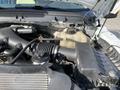 Engine compartment of a 2013 Ford F-450 SD showing various components including the air intake and coolant reservoir