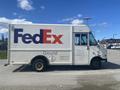 A 1999 Ford Econoline delivery truck with a FedEx logo on the side and text stating "Ground"