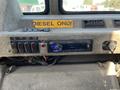 Interior dashboard controls of a 2010 Freightliner MT45 Garbage Truck featuring buttons for various functions and a Pioneer stereo system