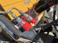 Close-up of two red safety plugs attached to hydraulic connectors on a yellow 2024 AGT KTT23 Mini Skid Steer