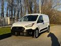 2022 Ford Transit Connect van with a white exterior and black accents parked on a pavement