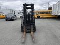 A 2011 Toyota Forklift with two metal forks positioned outward and a vertical mast for lifting loads.