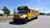 A yellow 2014 International 3000 school bus with a black front and large windows parked on a road