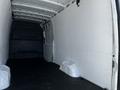 Interior view of a 2022 Mercedes-Benz Sprinter van showing a spacious, empty cargo area with white walls and a black floor