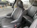 Interior view of a 2013 Toyota Sienna with black fabric and leather seats showing the driver's seat and the adjacent passenger seat