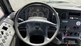 Interior view of the driver's seat area of a 2014 Freightliner Thomas Diesel bus featuring a steering wheel and dashboard controls