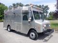 A 2007 Morgan Olson Workhorse W42 with a silver metallic exterior features a flat front, large windshield, multiple side compartments, and a light bar on top