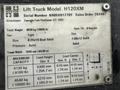 A metal identification plate for a Hyster H120XM lift truck displaying model number, serial number, weight specifications, tire sizes, and maximum capacity details