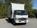 A white 2020 Hino 195 box truck is parked facing the camera with a large cargo area and visible front grille and headlights