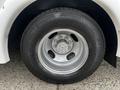 A close-up view of a silver wheel and tire from a 2017 Chevrolet Express with a five-spoke wheel design and tire tread visible