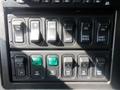 Control panel of a 2009 International 7400 featuring various toggle switches including engine brake, differential, park regen, and PTO controls