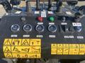 Control panel of a 2024 AGT KTT23 featuring various gauges and switches including fuel gauge hydraulic oil gauge and warning labels