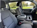 Interior view of a 2017 GMC Sierra 1500 showing the front seats and center console with storage compartments