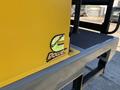 A close-up of a yellow engine cover with a Cummins logo sticker and "Power" text on a piece of machinery