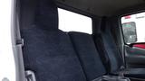 Interior view of a 2016 Hino 195 showing three dark fabric seats arranged in a row