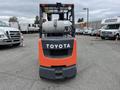 A 2011 Toyota Forklift with a gray and orange body featuring the Toyota logo on the front and a gas cylinder mounted on the rear