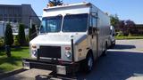 A 2005 Morgan Olson Workhorse delivery truck with a silver exterior and dual front windows parked in a lot