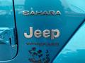 A blue 2020 Jeep Wrangler Sahara badge with the word Jeep prominently displayed above the text Wrangler Unlimited