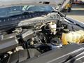 A 2019 Ford F-350 SD engine compartment showcasing the engine components and fluid reservoirs