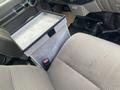 A grey 2009 Ford F-450 SD interior featuring a center console and fabric seats