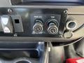 Control panel of a 2017 Chevrolet Express featuring knobs for rear air conditioning and temperature adjustment along with power switch and an outlet port