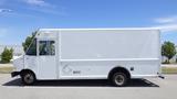 A white 2011 Ford Econoline truck with a boxy shape and large cargo space visible from the side