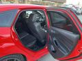 A red 2018 Ford Focus with an open rear door displaying black interior seating and dashboard details