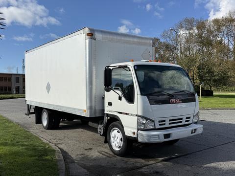 A 2007 GMC W5500 18 foot cube van with a white boxy cargo area and front cab featuring a grey interior and GMC branding on the grille