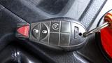 A black key fob for a 2014 RAM 5500 featuring buttons for locking unlocking and panic functions