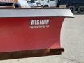A 2010 Ford F-550 snowplow blade with a red and gray color scheme featuring a Western Contractor grade logo