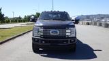 A 2017 Ford F-350 SD facing the camera with a glossy black exterior and a prominent front grille featuring the Ford logo