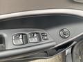 Interior door panel of a 2017 Hyundai Santa Fe with control buttons for windows and mirror adjustments