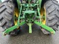 Front view of a 2003 John Deere 790 tractor showcasing its large rear tires and attached hitch system