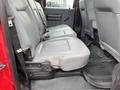 Interior view of the back seat of a 2011 Ford F-250 SD with three grey seats and a rubber floor mat