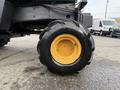 Close-up of a tire from a 1994 John Deere F1145 featuring a yellow rim and rugged black tread