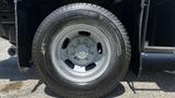 Close-up of the wheel and tire of a 2019 RAM 3500 displaying a gray wheel rim and a rugged tire tread