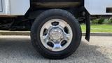 Close-up of a chrome wheel with a 2013 RAM 2500 tire showcasing its tread and shiny rim