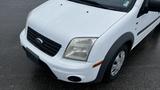 A white 2012 Ford Transit van with a black grille and large headlights visible from a high angle view