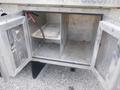 Open storage compartment of a 2007 Morgan Olson Workhorse W42 showing two sections with a metal floor and a loose wire running inside