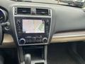 The interior of a 2019 Subaru Outback featuring a dashboard with a touchscreen navigation system and various control knobs