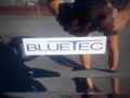 A close-up view of a BLUETEC badge on a 2013 Mitsubishi Fuso FE 160 vehicle