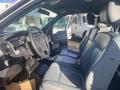 Interior view of a 2013 Ford F-150 featuring leather seats and a dashboard with controls and a steering wheel