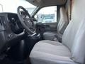 Interior view of a 2009 GMC Savana showcasing the driver's seat and dashboard with a steering wheel and gear console