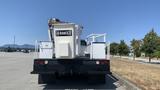 A 2011 Ford F-450 SD with a white bucket lift in the back and a Hi-Ranger sign attached to the lift equipment