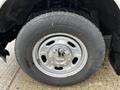 Close-up of a silver alloy wheel with a tire on a 2011 Ford F-250 SD