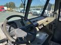 Interior view of a 2010 Freightliner MT45 garbage truck featuring a steering wheel dashboard and control panel