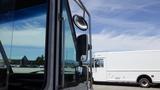 A 2011 Ford Econoline view from the driver's side showing the mirror and part of the window