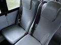 Two grey bus seats with seatbelts attached, designed for passenger safety in a 2016 International 4200 vehicle